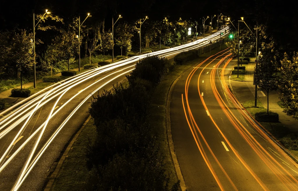 Long-exposure light trails of highway traffic at night
