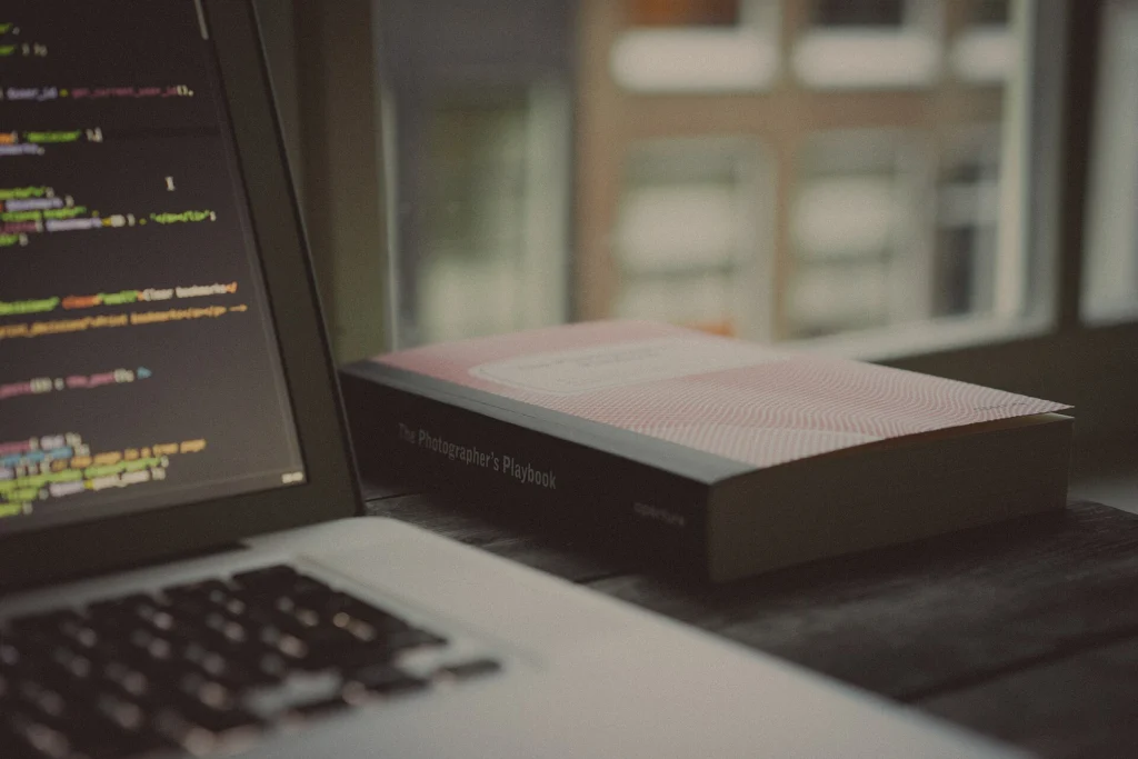 Performance: Laptop with source code on screen next to a coffee cup on a desk