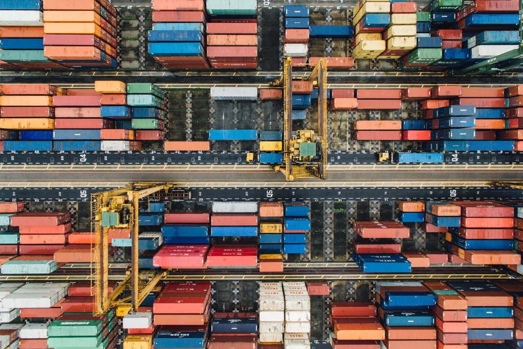 Aerial view of a container terminal with cranes arranging shipping containers