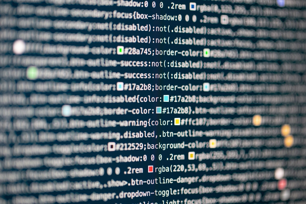 CQRS: Close-up of source code on a dark computer screen with colored highlights