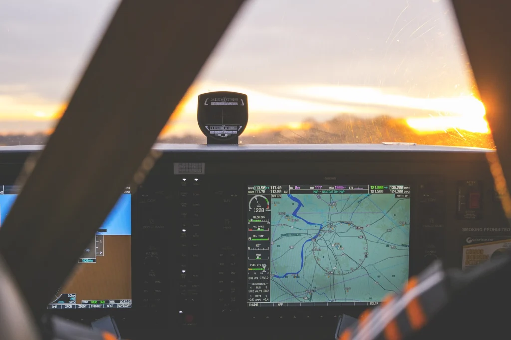 Aircraft cockpit instruments glowing at sunset before take-off