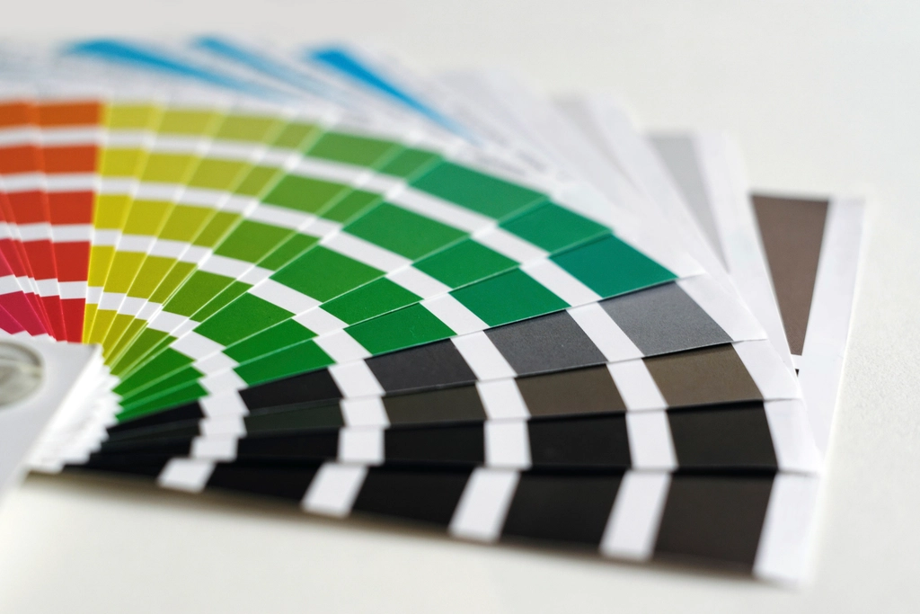 Fanned-out colour swatch cards showing gradients of green, yellow and grey