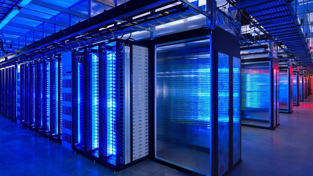 Rows of server racks under blue lighting in a modern data center