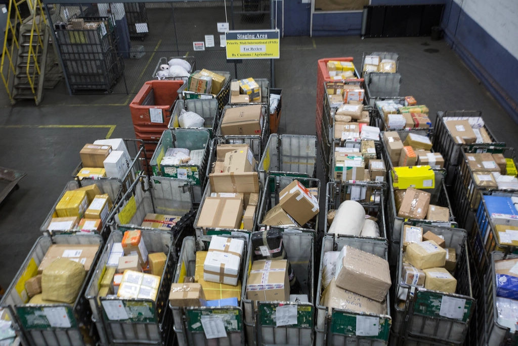 Bins full of parcels and packages waiting for sorting in a mail facility