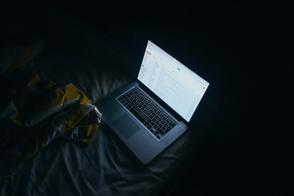 Laptop screen of text in a dark room for AI citations