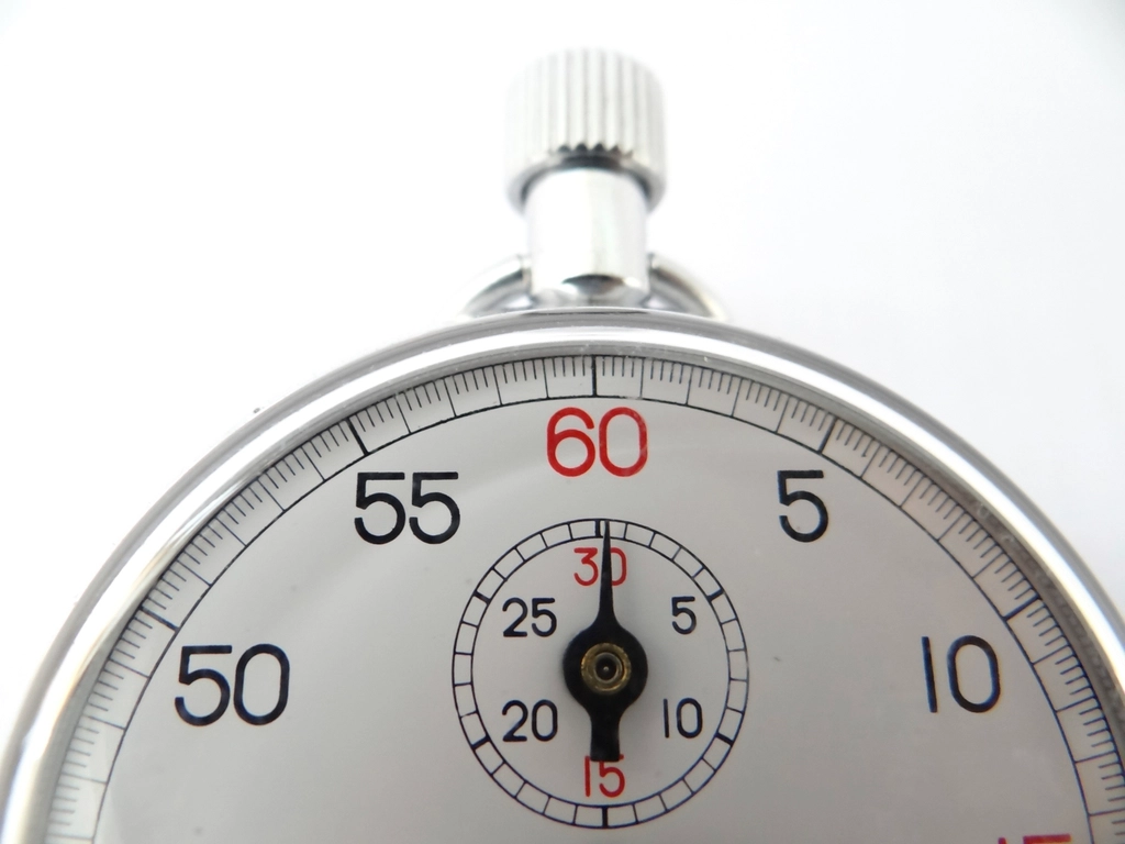 Close-up of a silver sports stopwatch dial on a white background