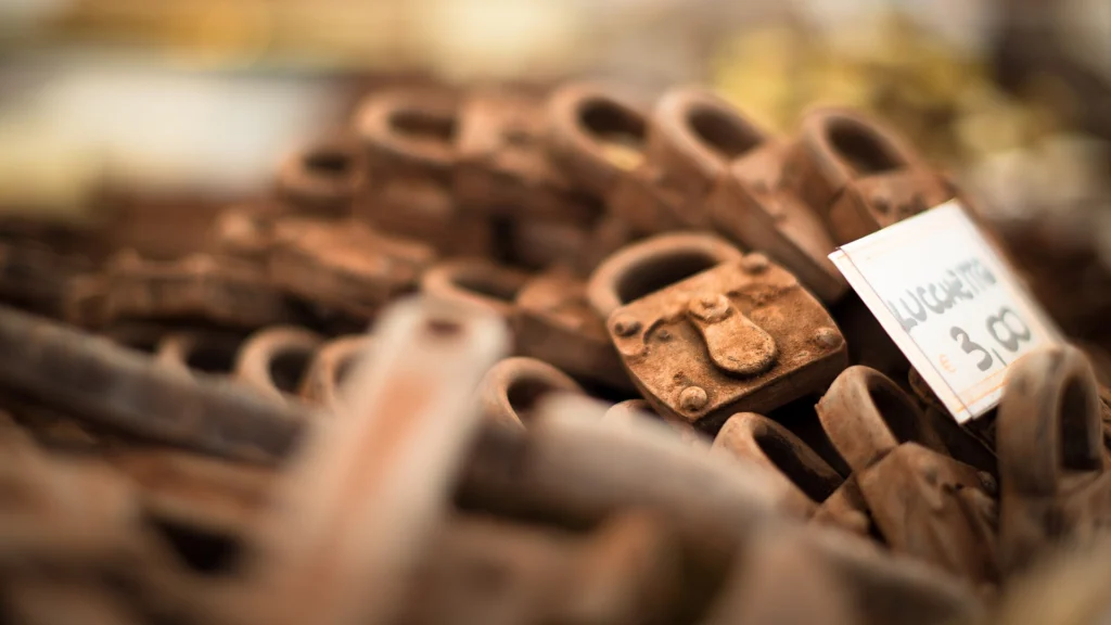 Heap of rusty padlocks with a small handwritten price tag