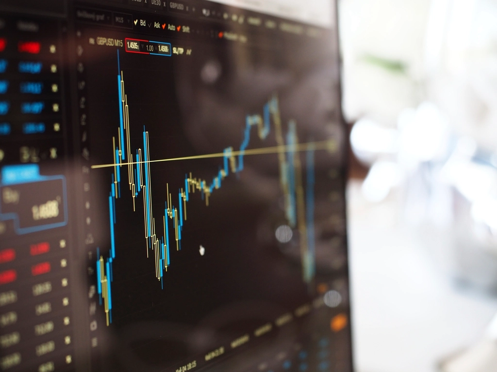 Monitor displaying live market charts and constantly updating numbers