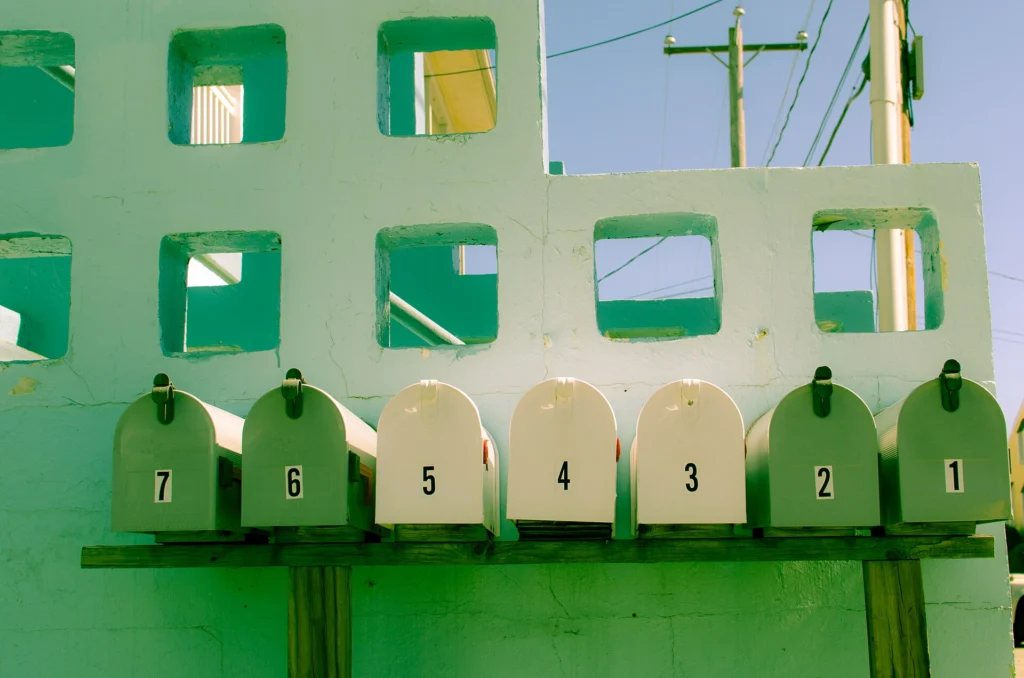 Row of numbered mailboxes from one to seven standing side by side
