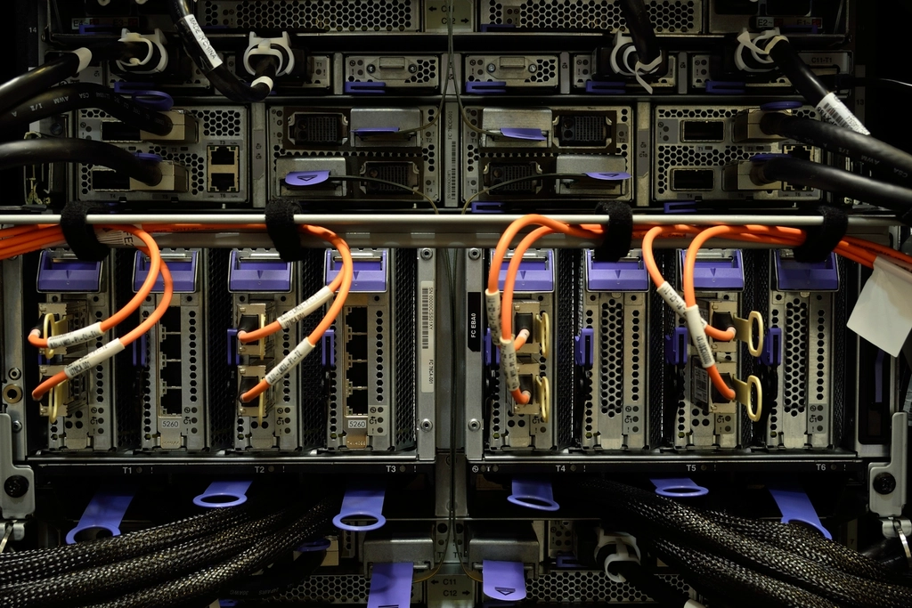 Back of server hardware with neatly routed orange fiber cables