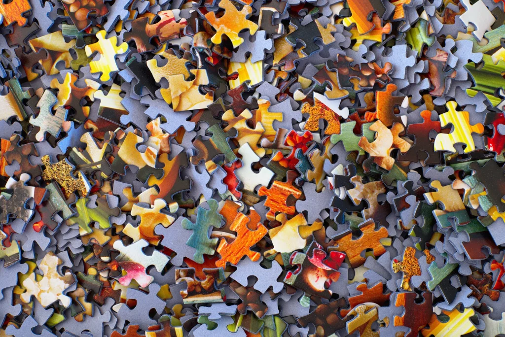 REST: Pile of colorful jigsaw puzzle pieces waiting to be connected
