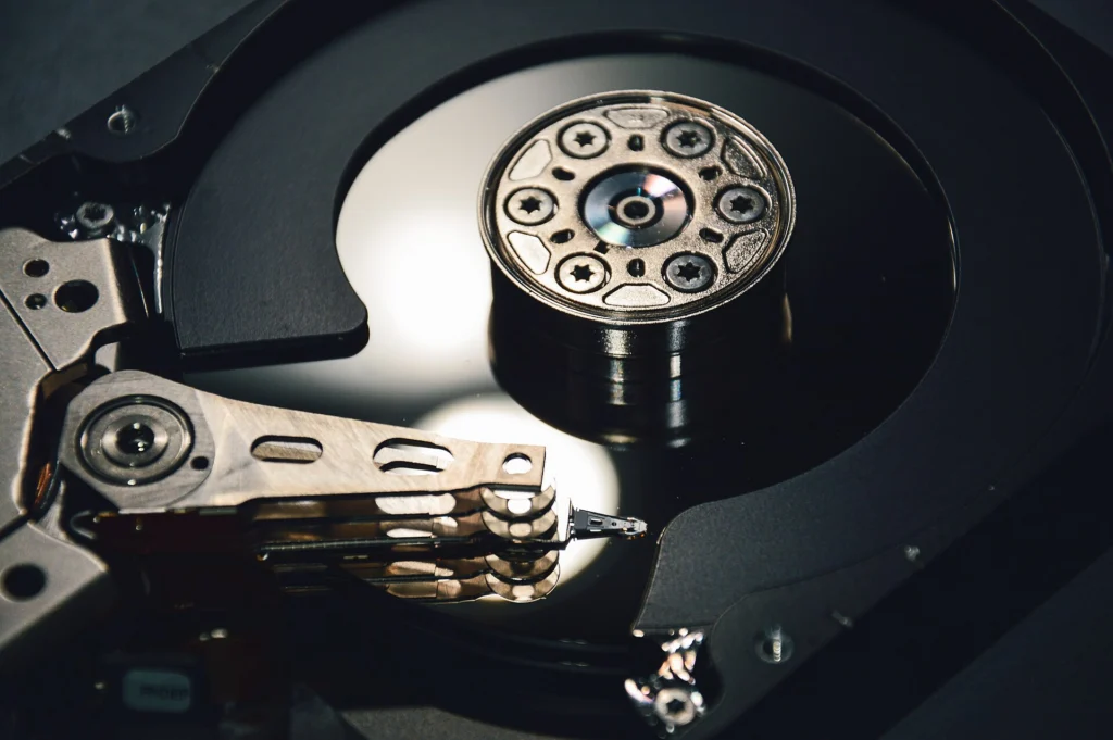 Close-up of an open hard disk drive showing the platter and read arm
